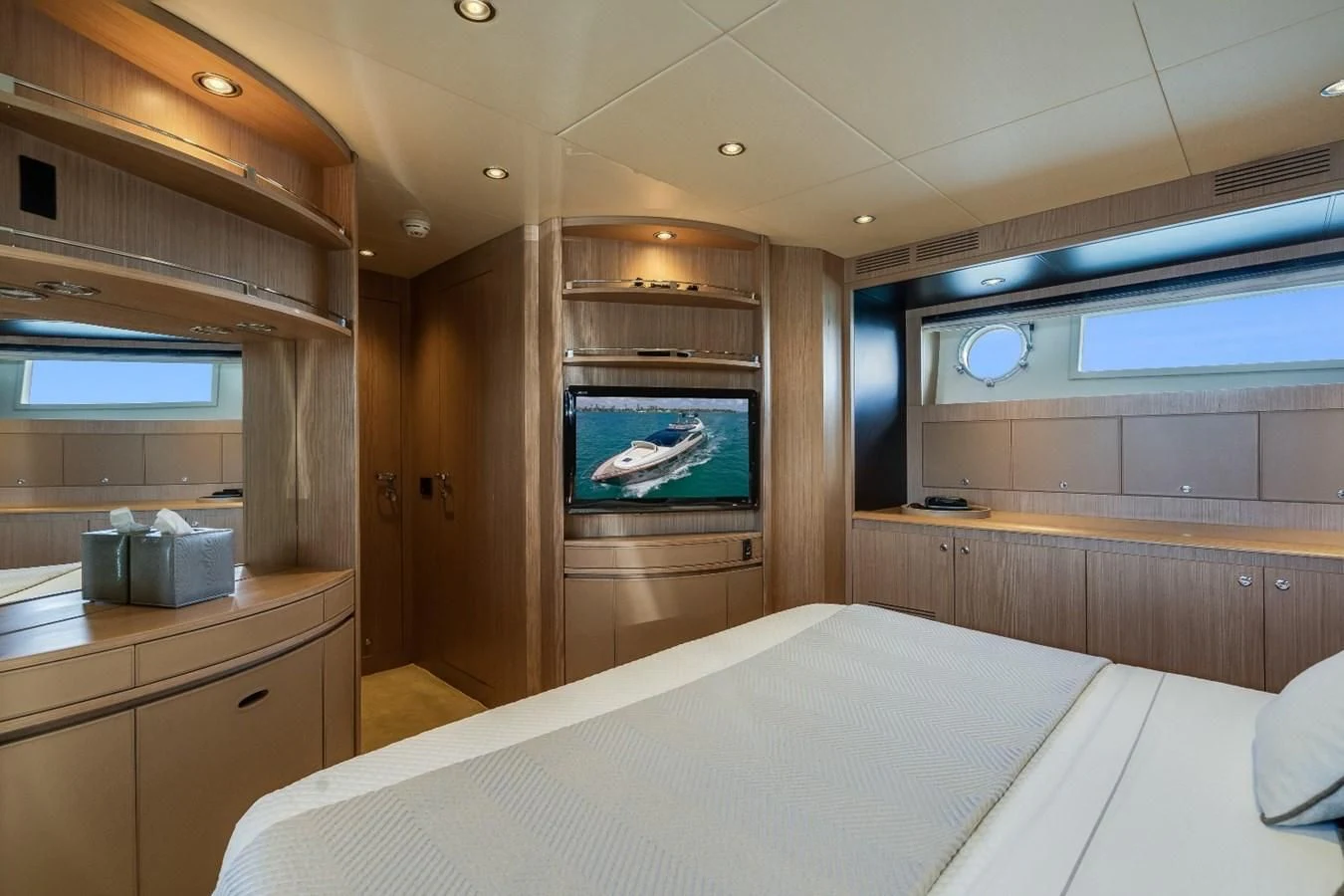 a room with a bed and a television aboard NAMEDROPPER Yacht for Sale