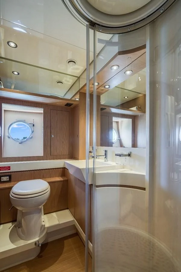 a bathroom with a toilet and tub aboard NAMEDROPPER Yacht for Sale