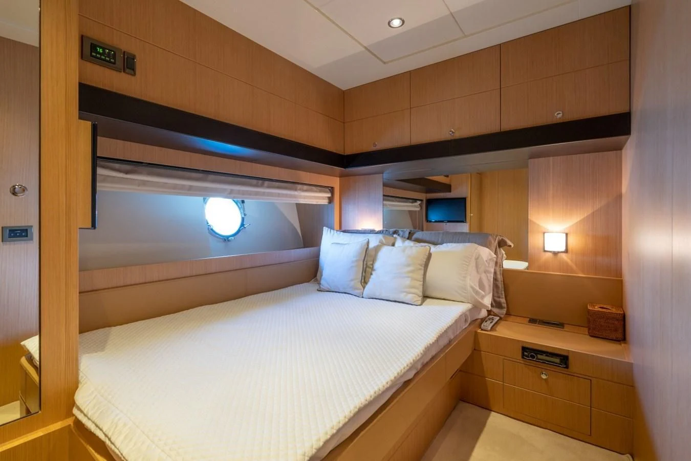 a room with a bed and a television aboard NAMEDROPPER Yacht for Sale