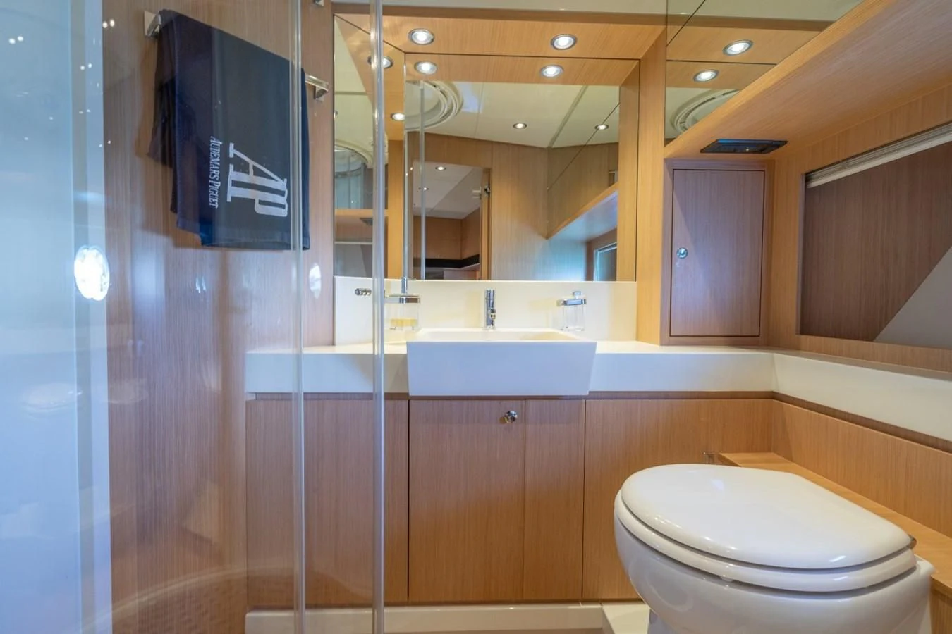 a bathroom with a toilet and a sink aboard NAMEDROPPER Yacht for Sale