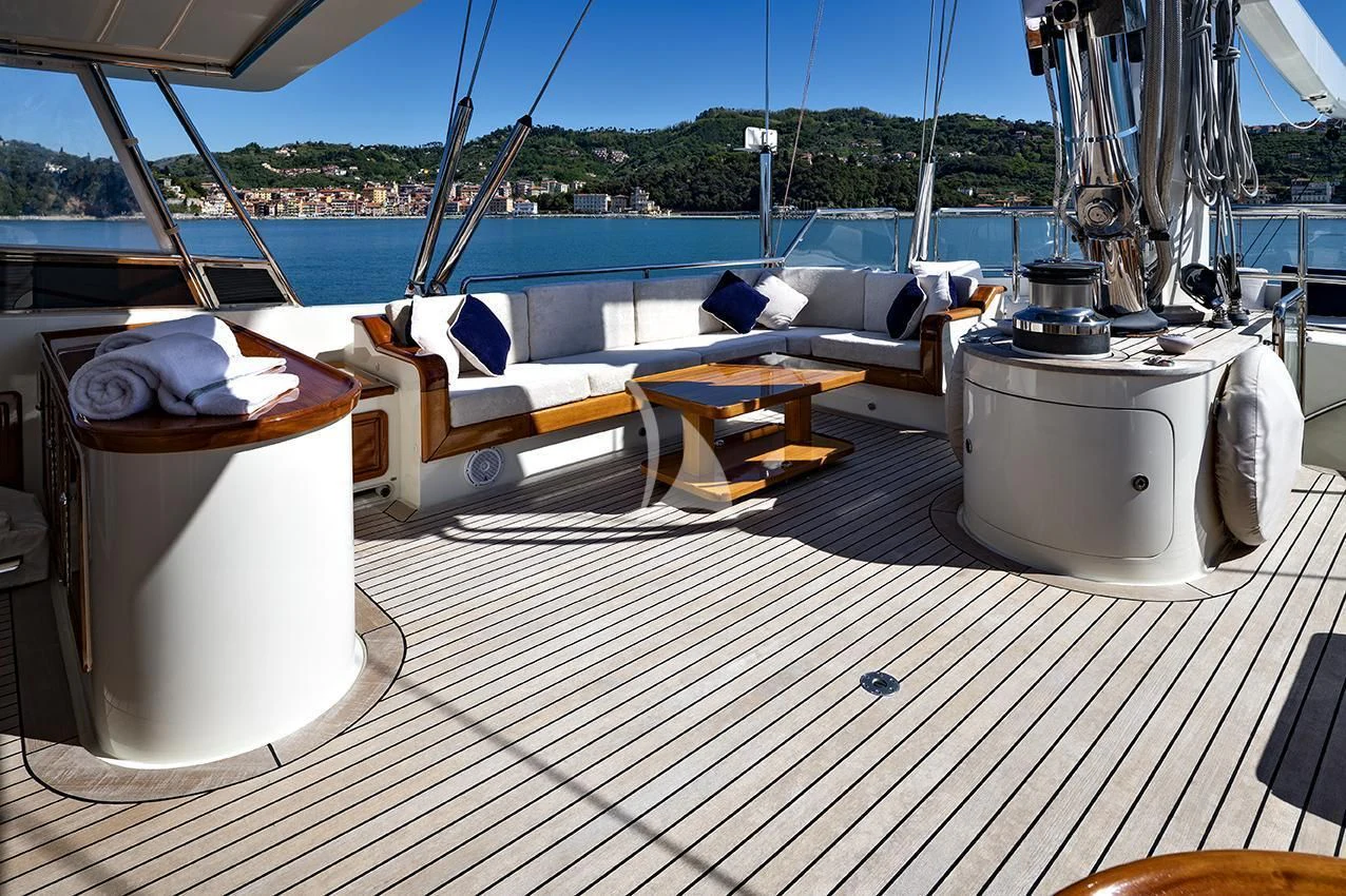 a boat deck with a deck and a deck with a view of the water and trees aboard JASALI II Yacht for Charter