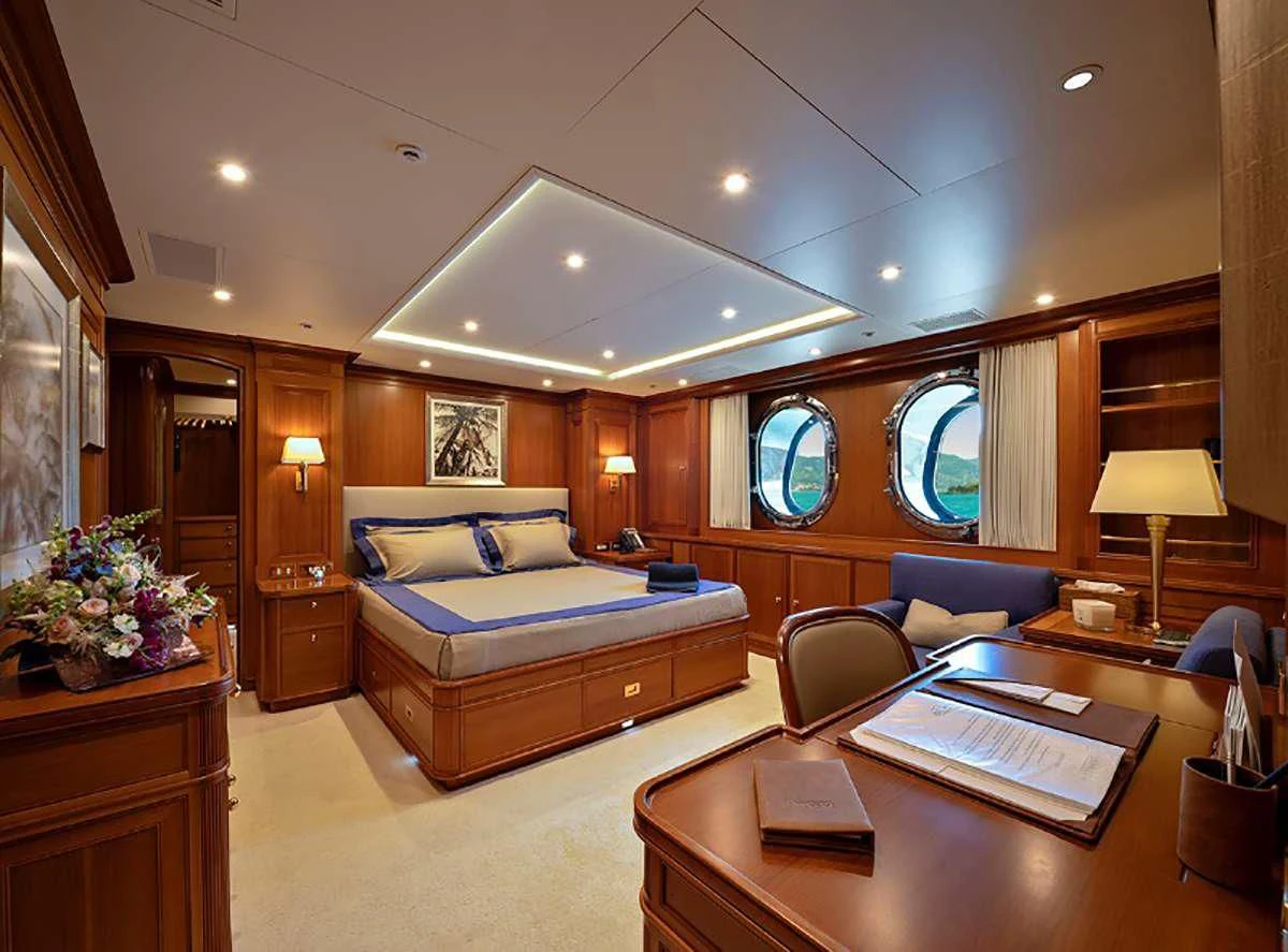 a bedroom with a bed and a desk aboard JASALI II Yacht for Charter