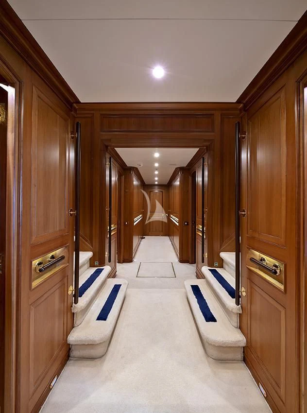 a hallway with wood cabinets aboard JASALI II Yacht for Charter