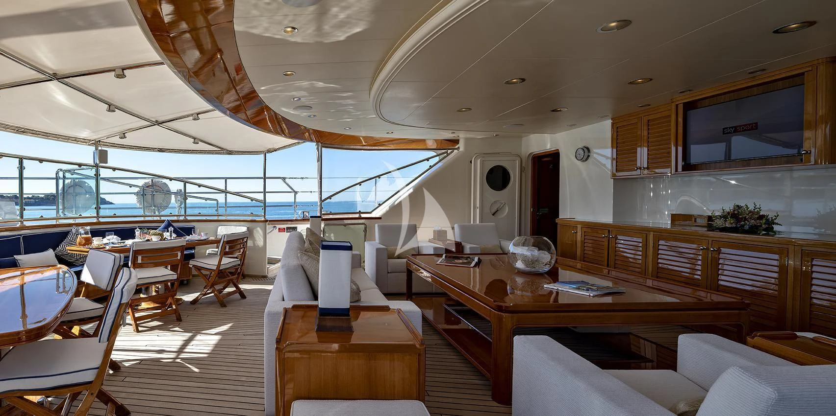 a room with tables and chairs aboard JASALI II Yacht for Charter
