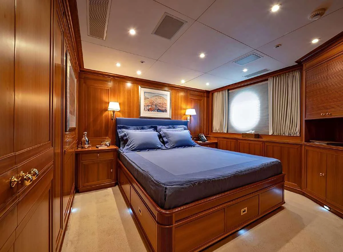 a bedroom with a bed and cabinets aboard JASALI II Yacht for Charter