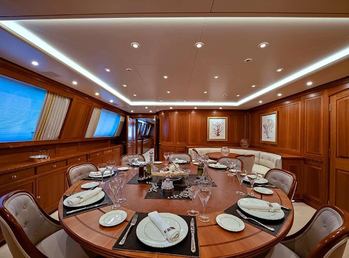 a dining room with a table set aboard JASALI II Yacht for Charter