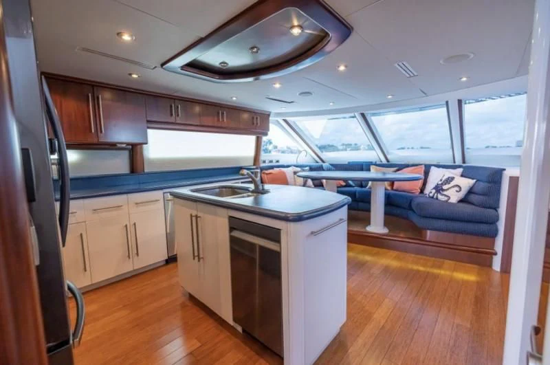 a kitchen with a large window aboard CORAGGIO Yacht for Sale