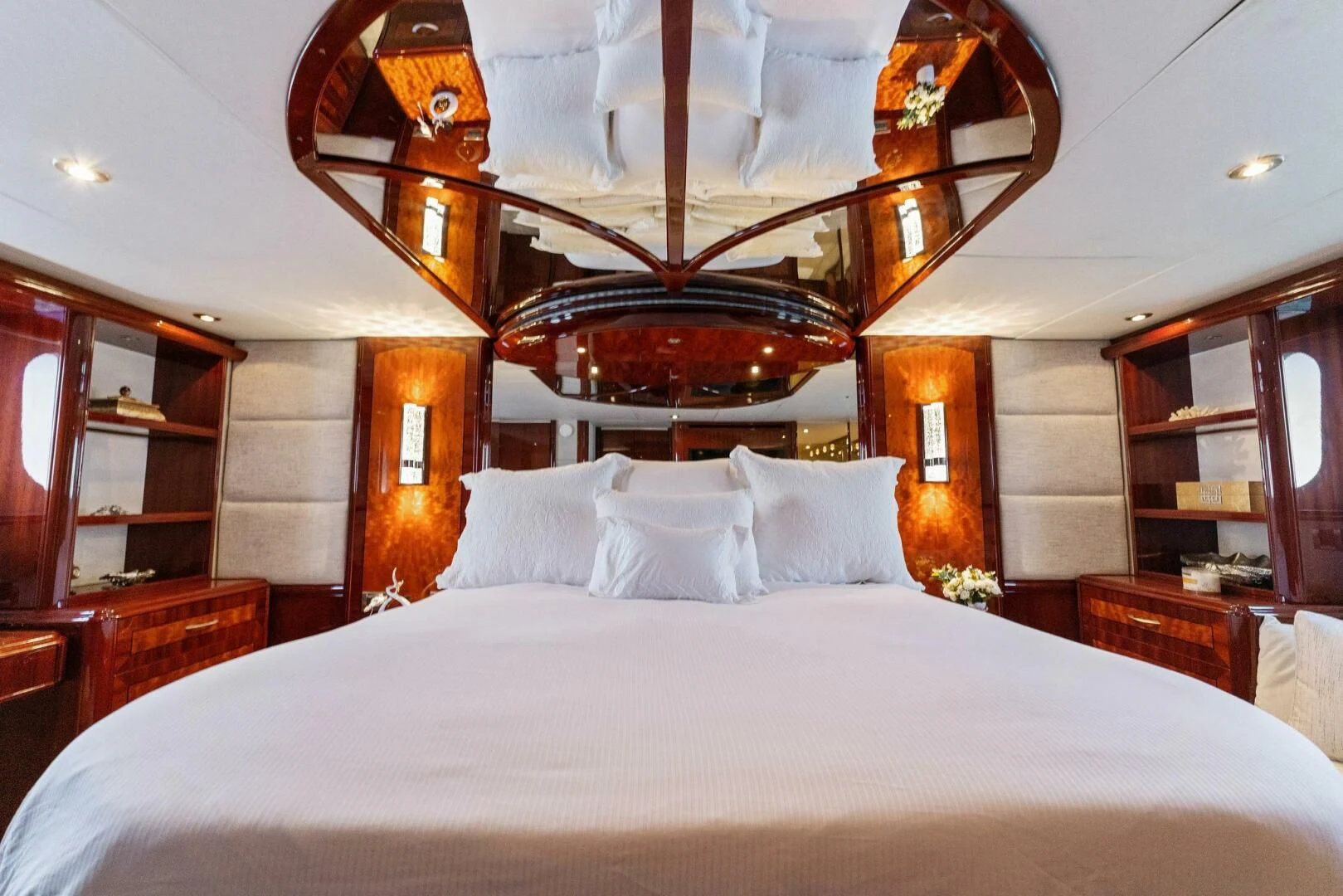 a bed with white sheets and pillows aboard CORAGGIO Yacht for Sale