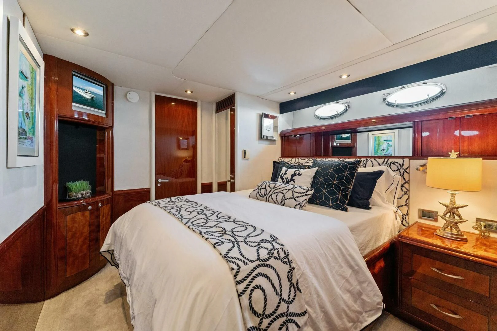 a bedroom with a bed and a desk aboard CORAGGIO Yacht for Sale