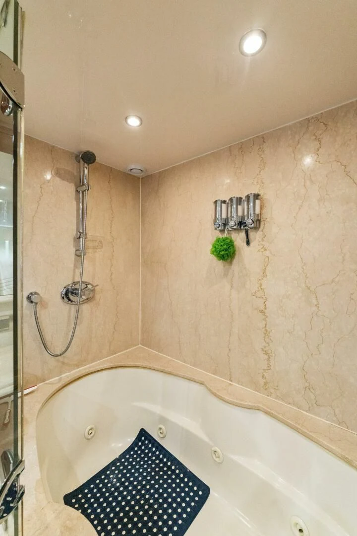 a bathroom with a shower and tub aboard CORAGGIO Yacht for Sale