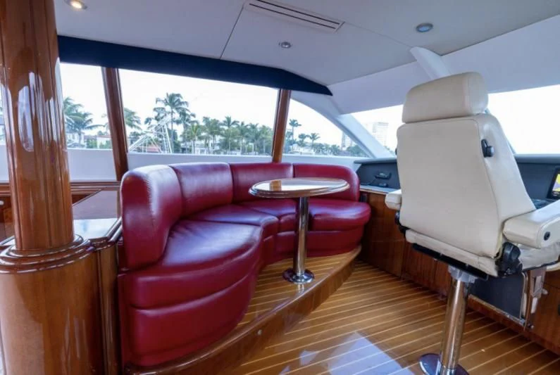 a room with a table and chairs aboard CORAGGIO Yacht for Sale