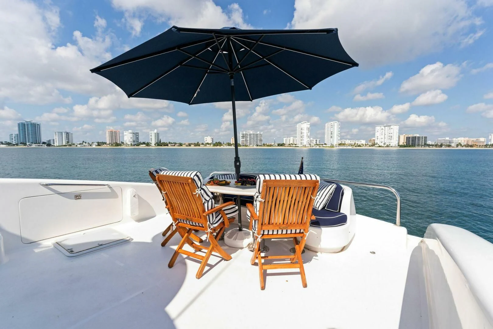 a table and chairs on a beach aboard CORAGGIO Yacht for Sale