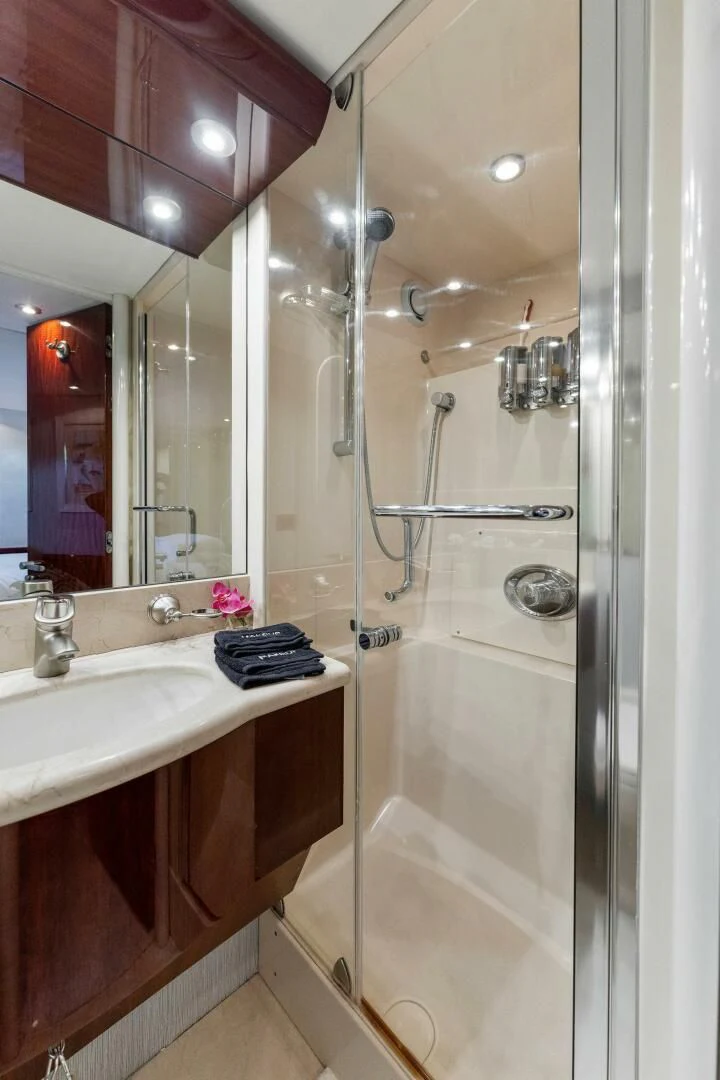 a bathroom with a glass shower aboard CORAGGIO Yacht for Sale