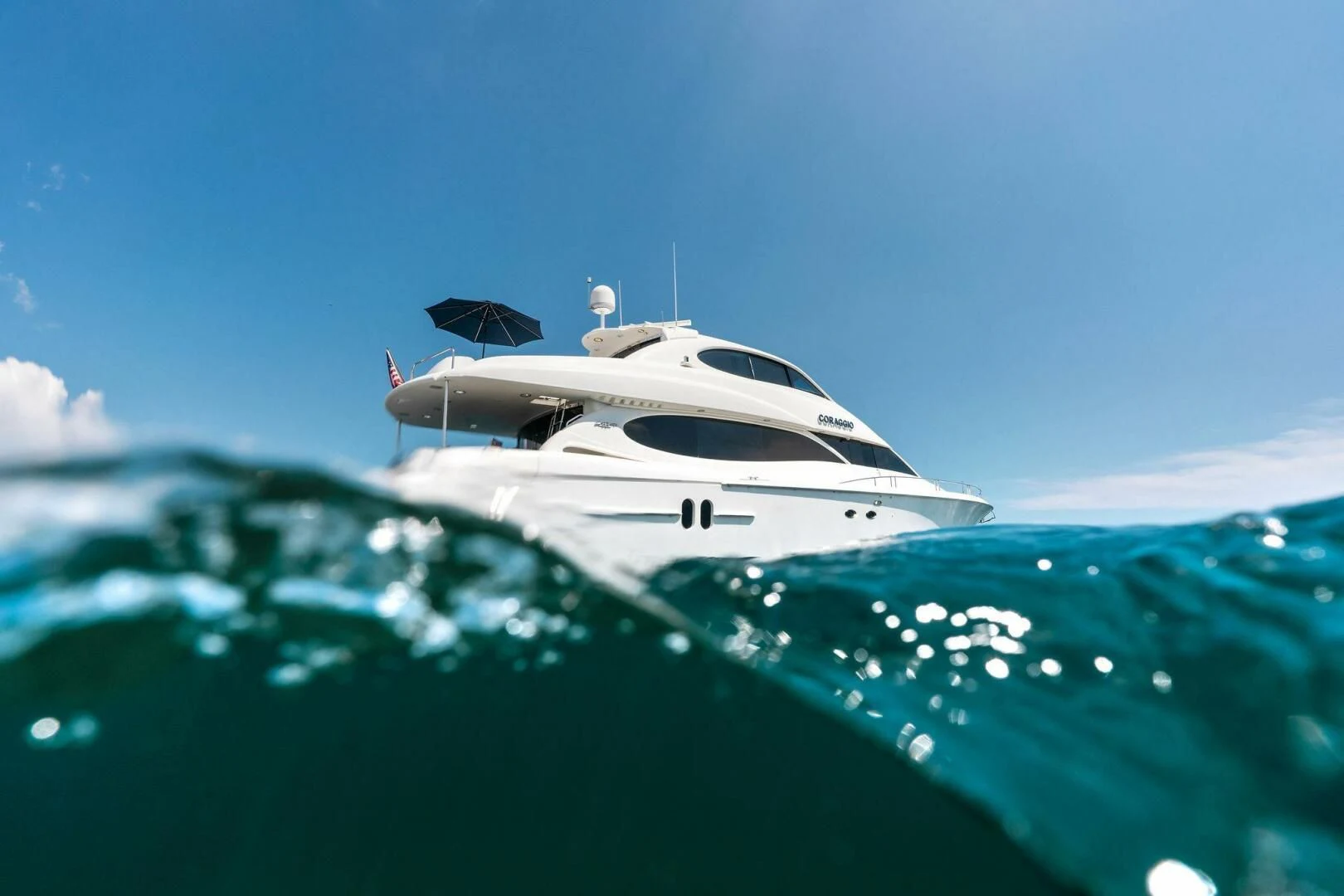 a white yacht on a blue sea aboard CORAGGIO Yacht for Sale