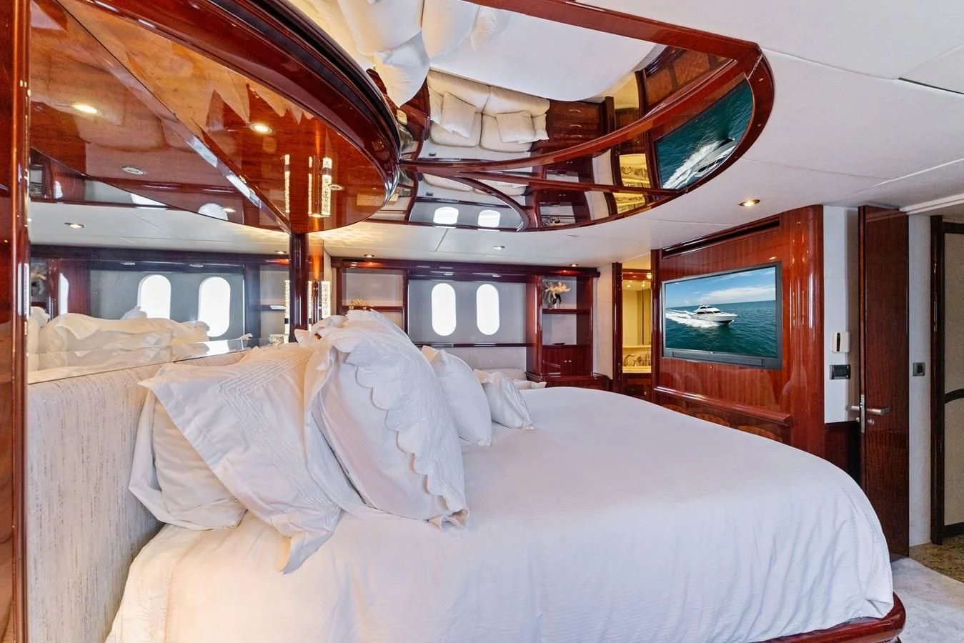 a room with a bed and a television aboard CORAGGIO Yacht for Sale