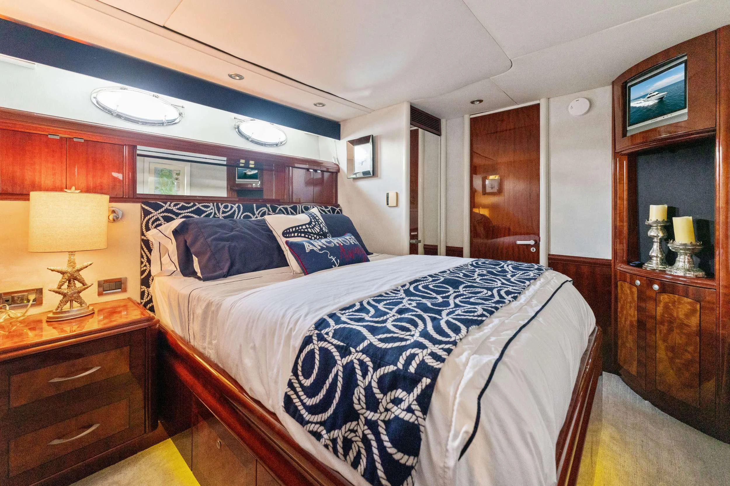 a bedroom with a bed and a desk aboard CORAGGIO Yacht for Sale