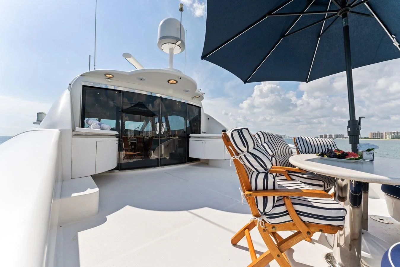a boat with a table and umbrella aboard CORAGGIO Yacht for Sale