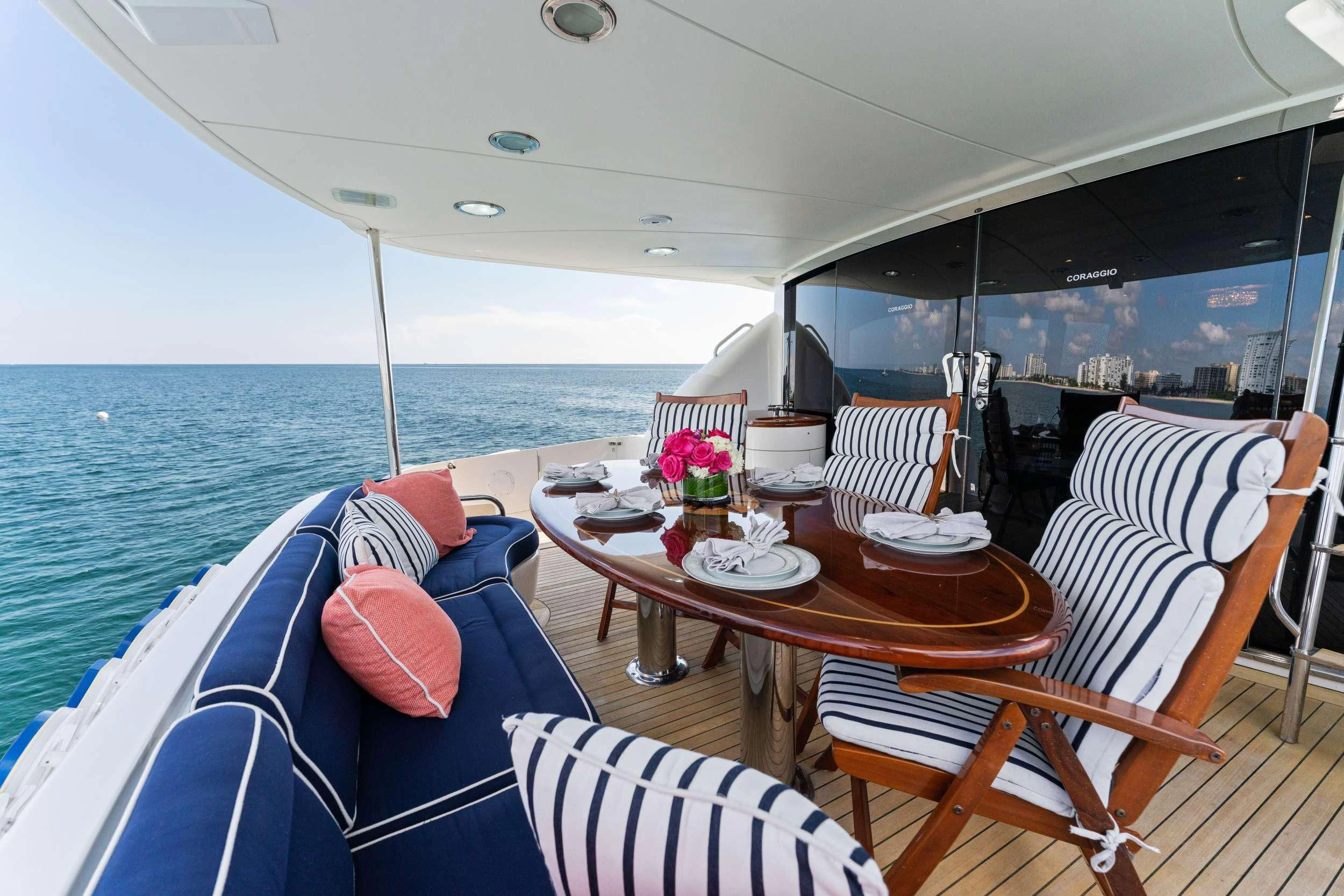 a boat with a table and chairs on it aboard CORAGGIO Yacht for Sale