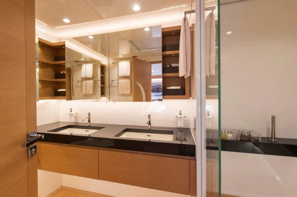 a bathroom with a glass shower aboard KIWAYU Yacht for Charter