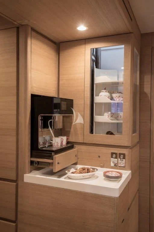 a kitchen with a microwave oven and a couple of plates of food aboard KIWAYU Yacht for Charter