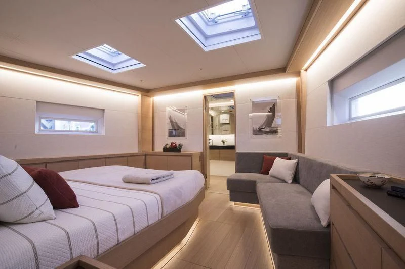 a bedroom with a bed and a couch aboard KIWAYU Yacht for Charter