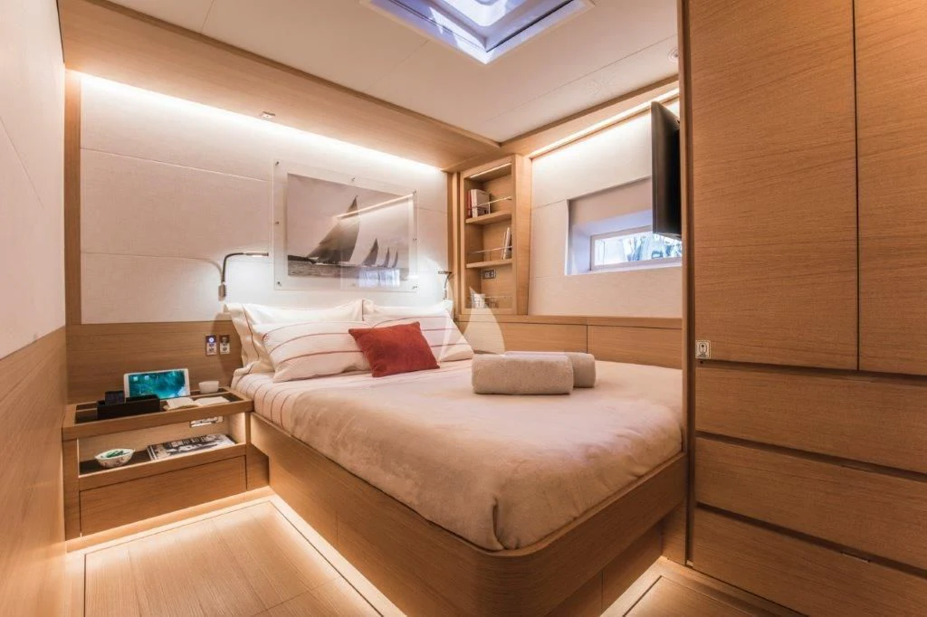 a bedroom with a bed and a desk aboard KIWAYU Yacht for Charter