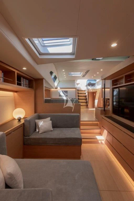 a living room with a couch and a tv aboard KIWAYU Yacht for Charter