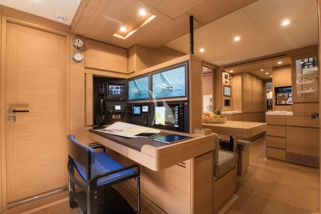 a room with a desk and chairs aboard KIWAYU Yacht for Charter