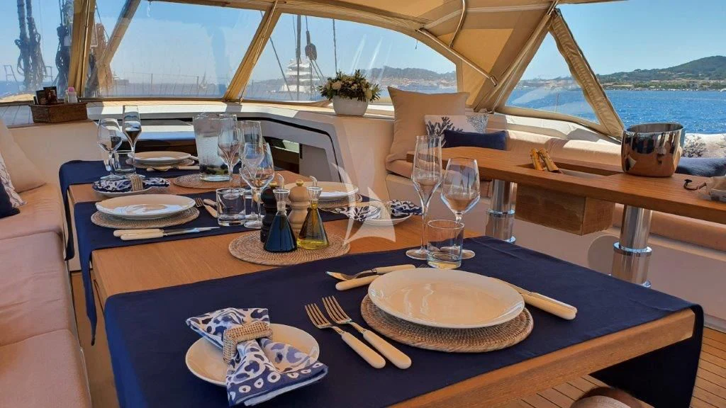 a table with plates and glasses on it aboard KIWAYU Yacht for Charter