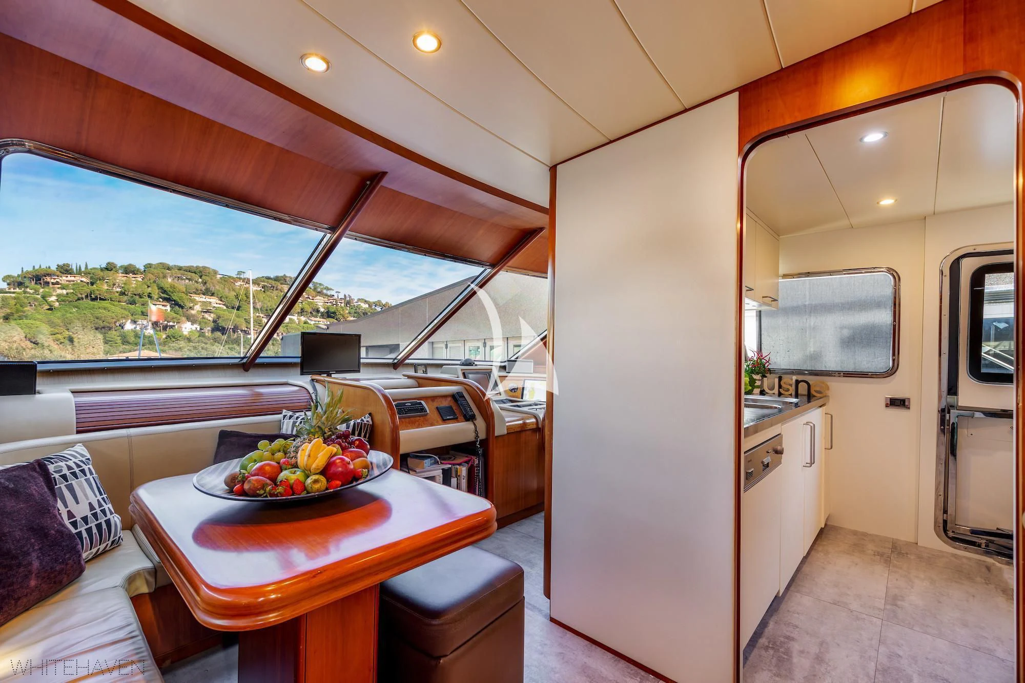 a room with a table and a bed and a window aboard WHITEHAVEN Yacht for Sale