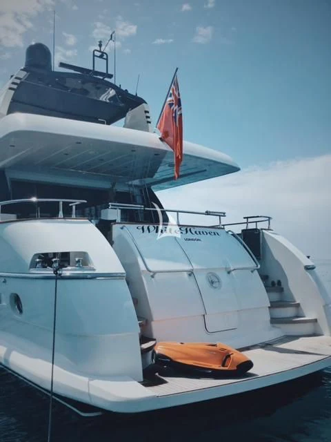a boat with a flag on the front aboard WHITEHAVEN Yacht for Sale