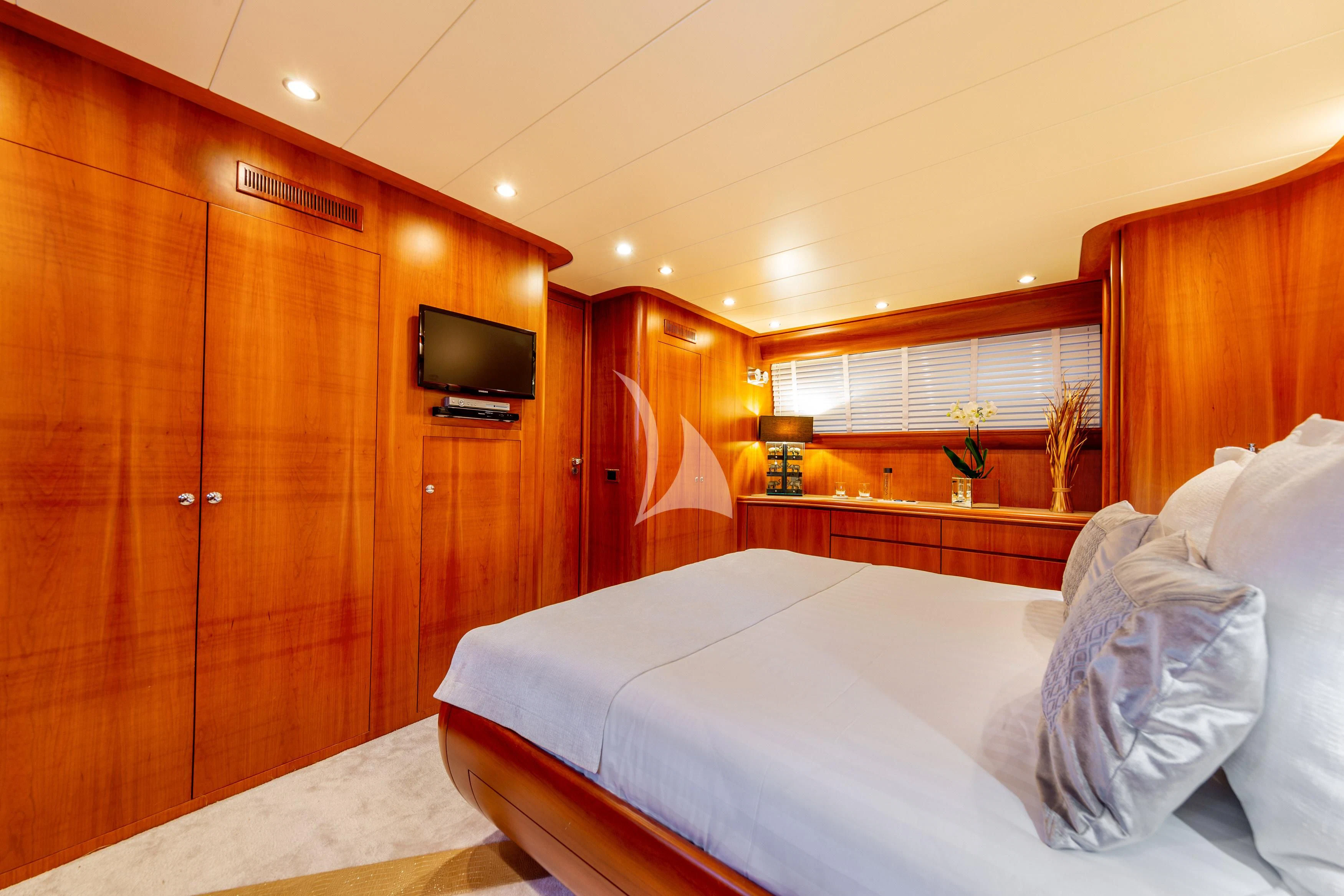 a bedroom with a bed and a television aboard WHITEHAVEN Yacht for Sale