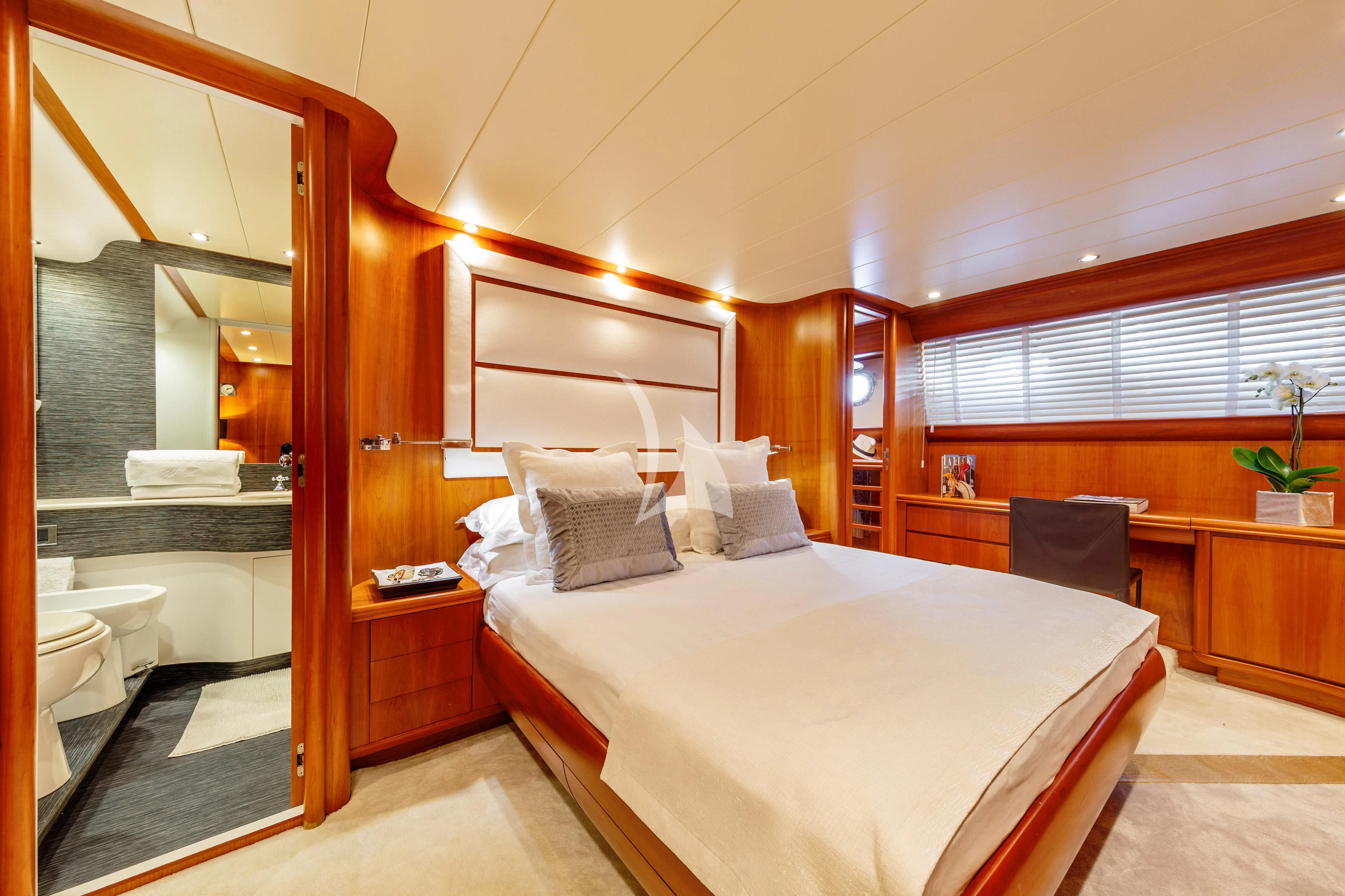 a bedroom with a bed and a mirror aboard WHITEHAVEN Yacht for Sale