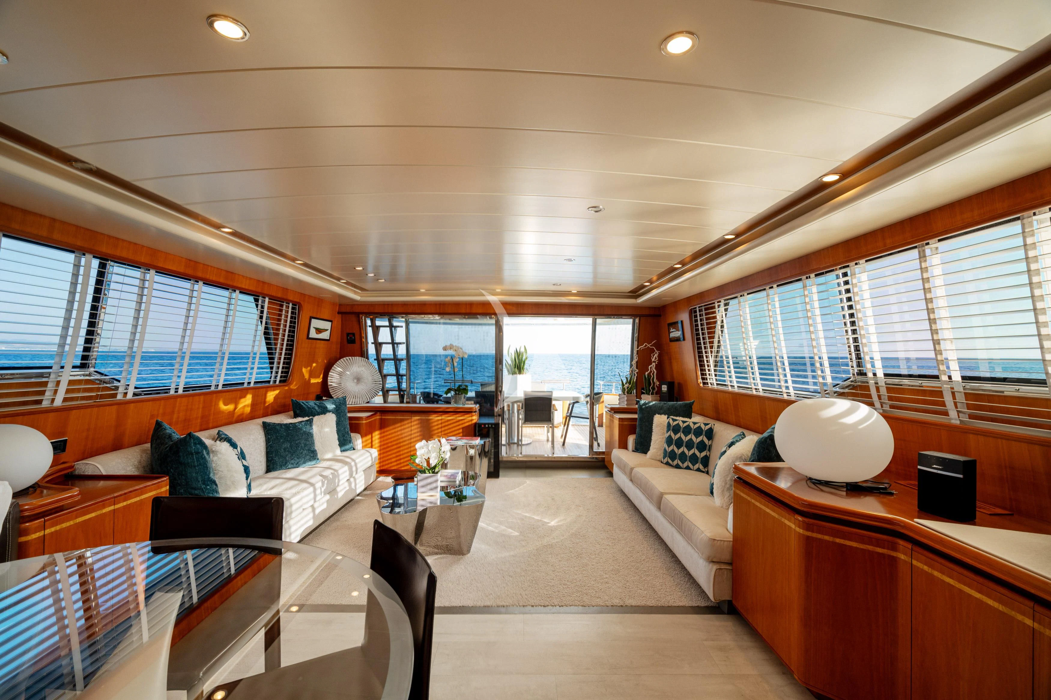 a room with a couch and a table and a lamp aboard WHITEHAVEN Yacht for Sale