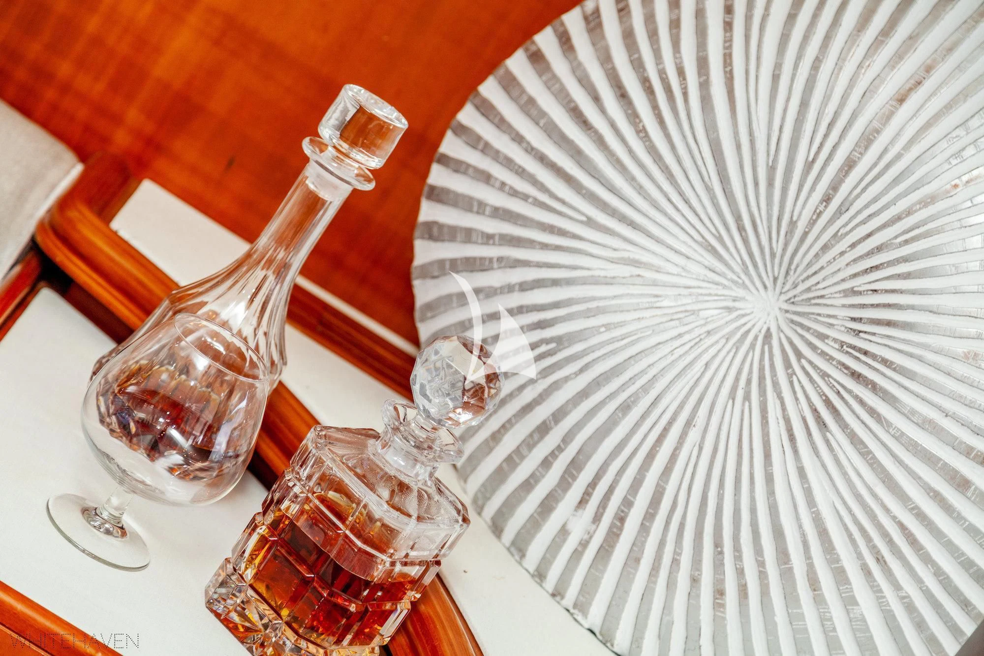 a glass of wine and a white umbrella on a table aboard WHITEHAVEN Yacht for Sale