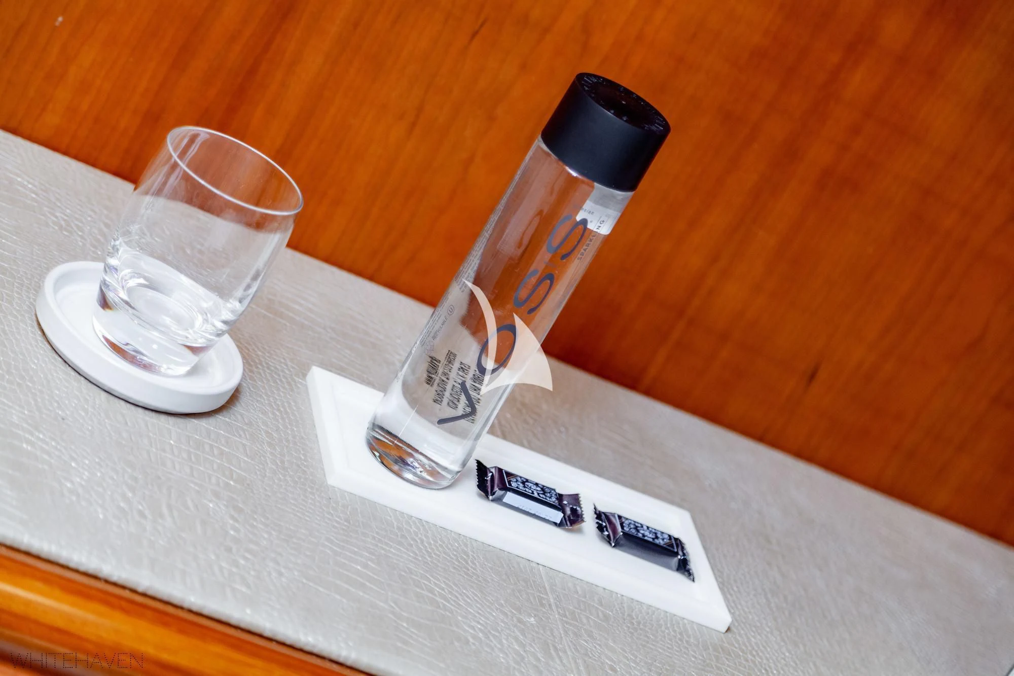 a bottle and a glass on a table aboard WHITEHAVEN Yacht for Sale