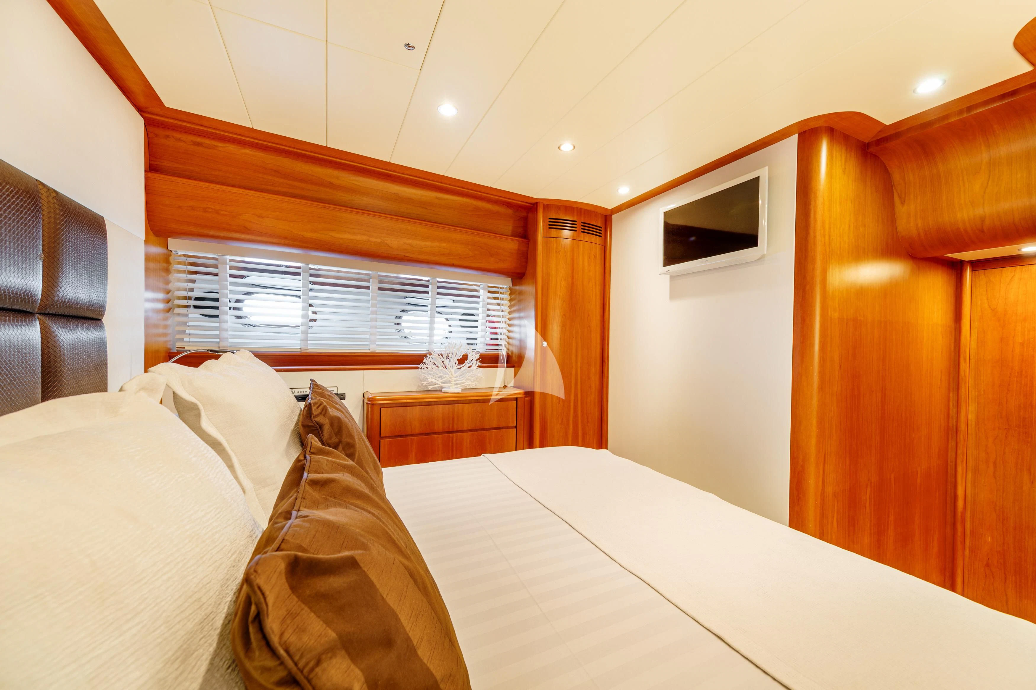 a bedroom with a bed and a window aboard WHITEHAVEN Yacht for Sale