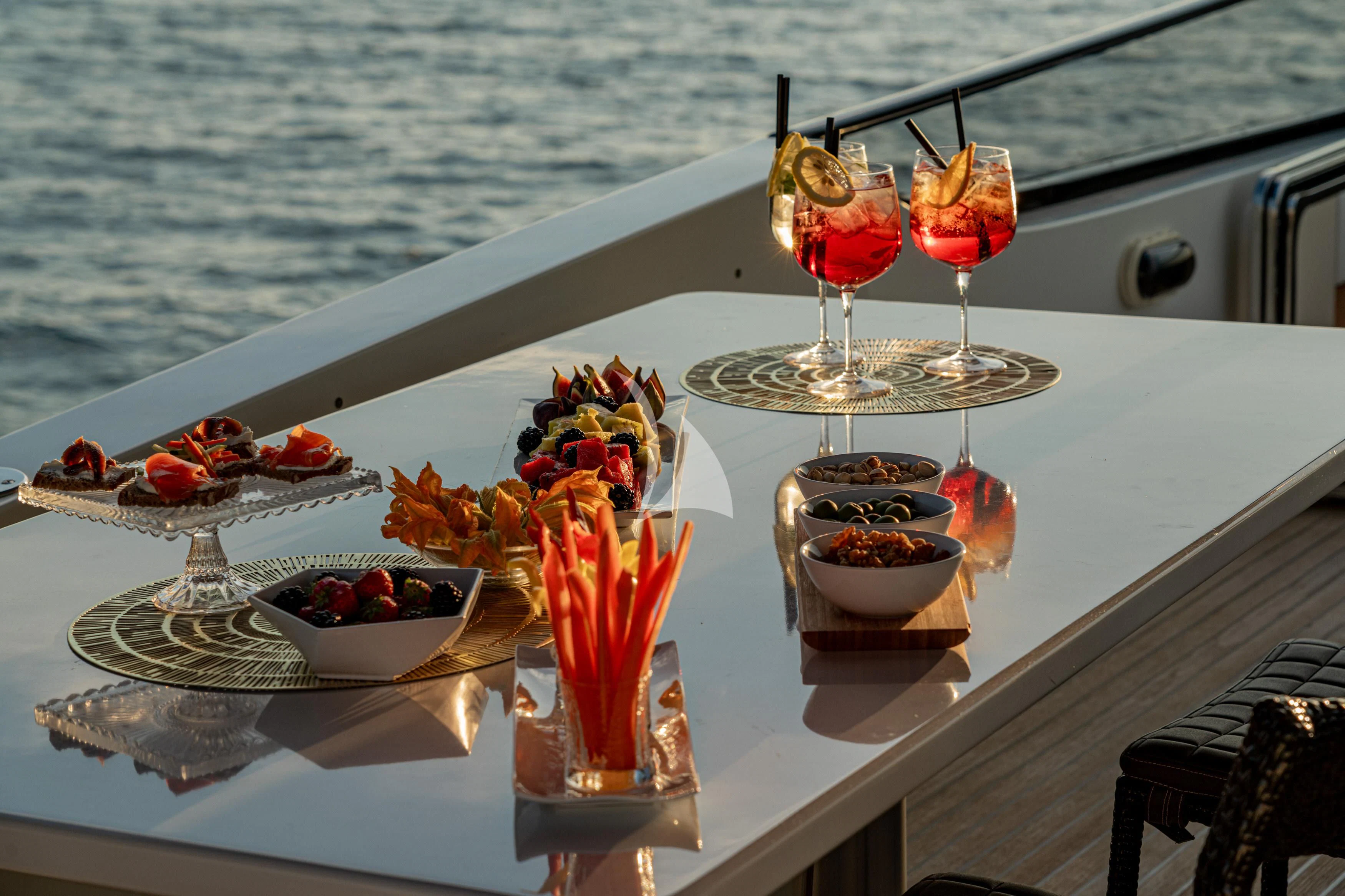 a table with food and drinks on it aboard WHITEHAVEN Yacht for Sale