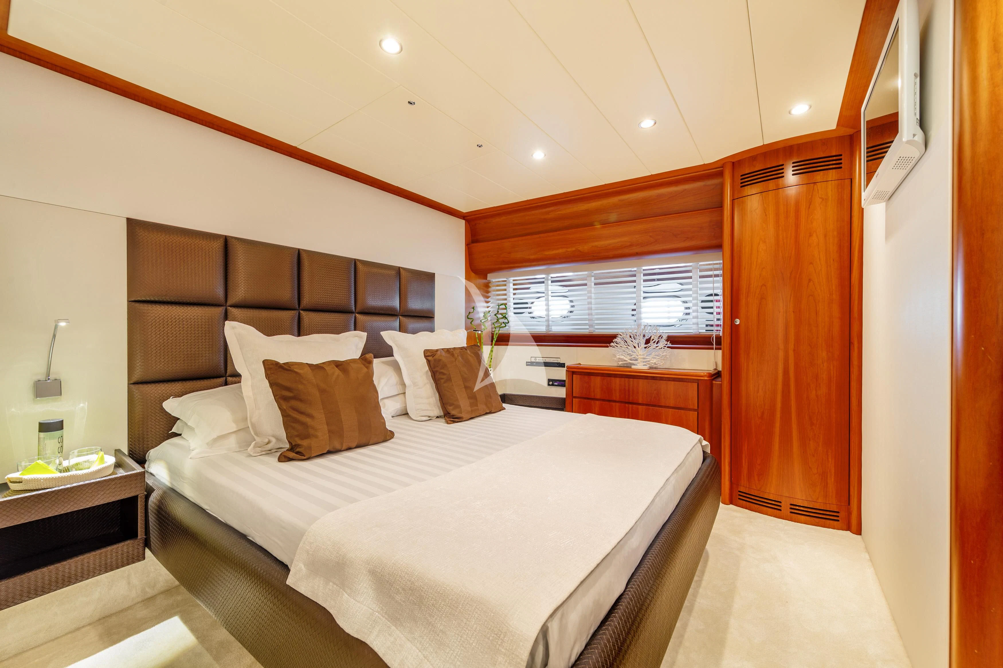 a bedroom with a bed and a window aboard WHITEHAVEN Yacht for Sale