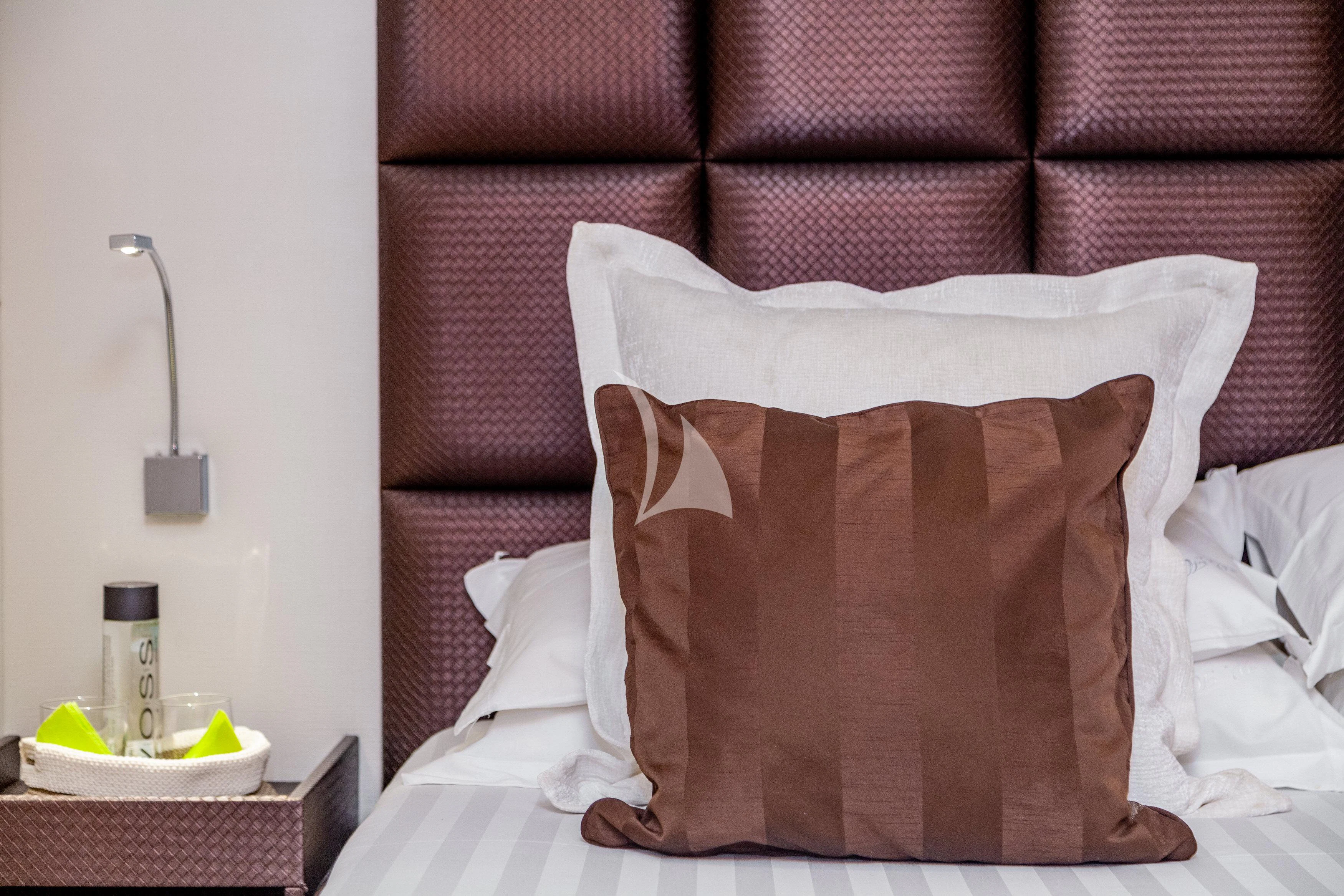 a brown and white pillow on a bed aboard WHITEHAVEN Yacht for Sale