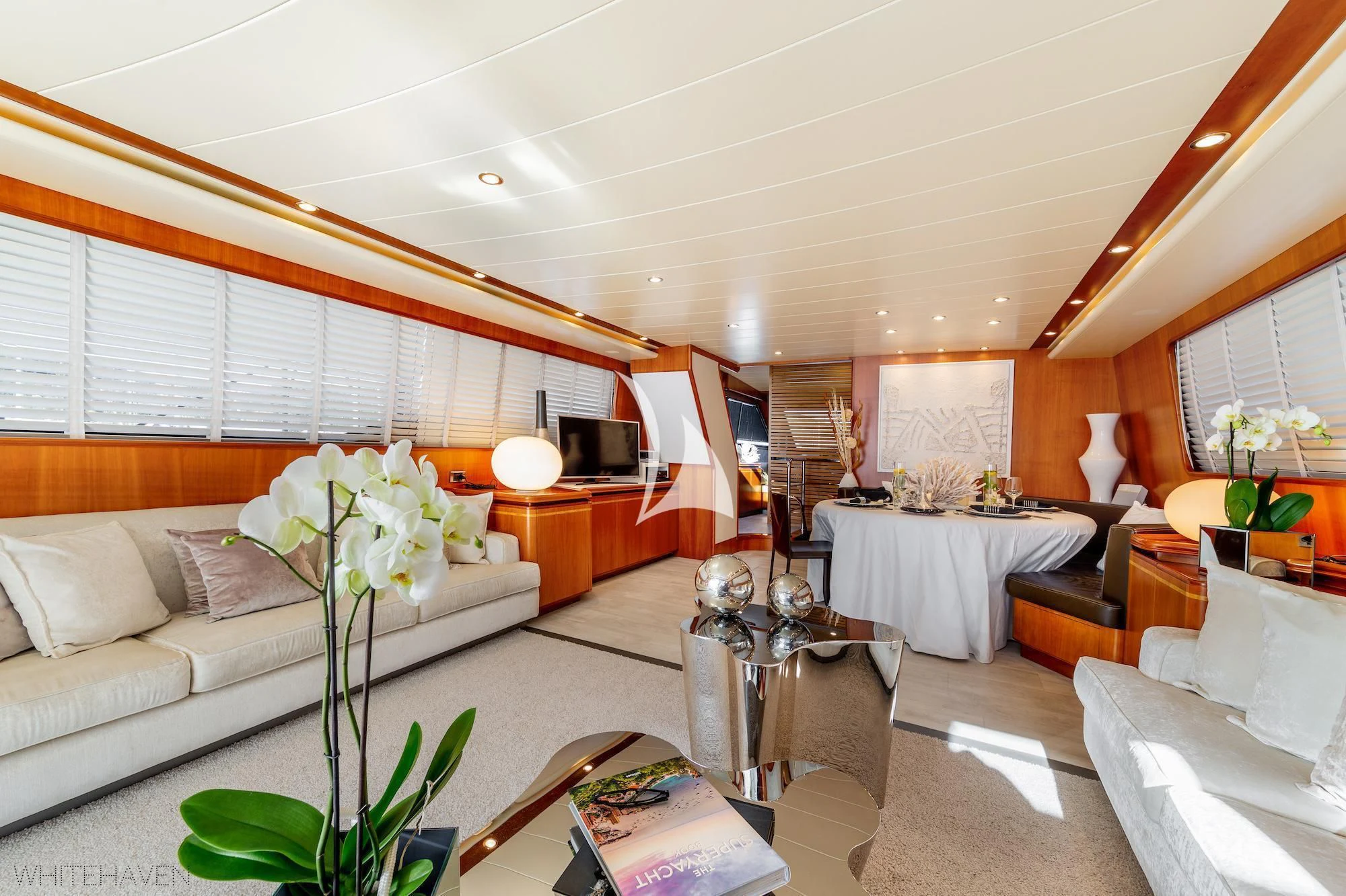 a living room with a white couch and a table aboard WHITEHAVEN Yacht for Sale