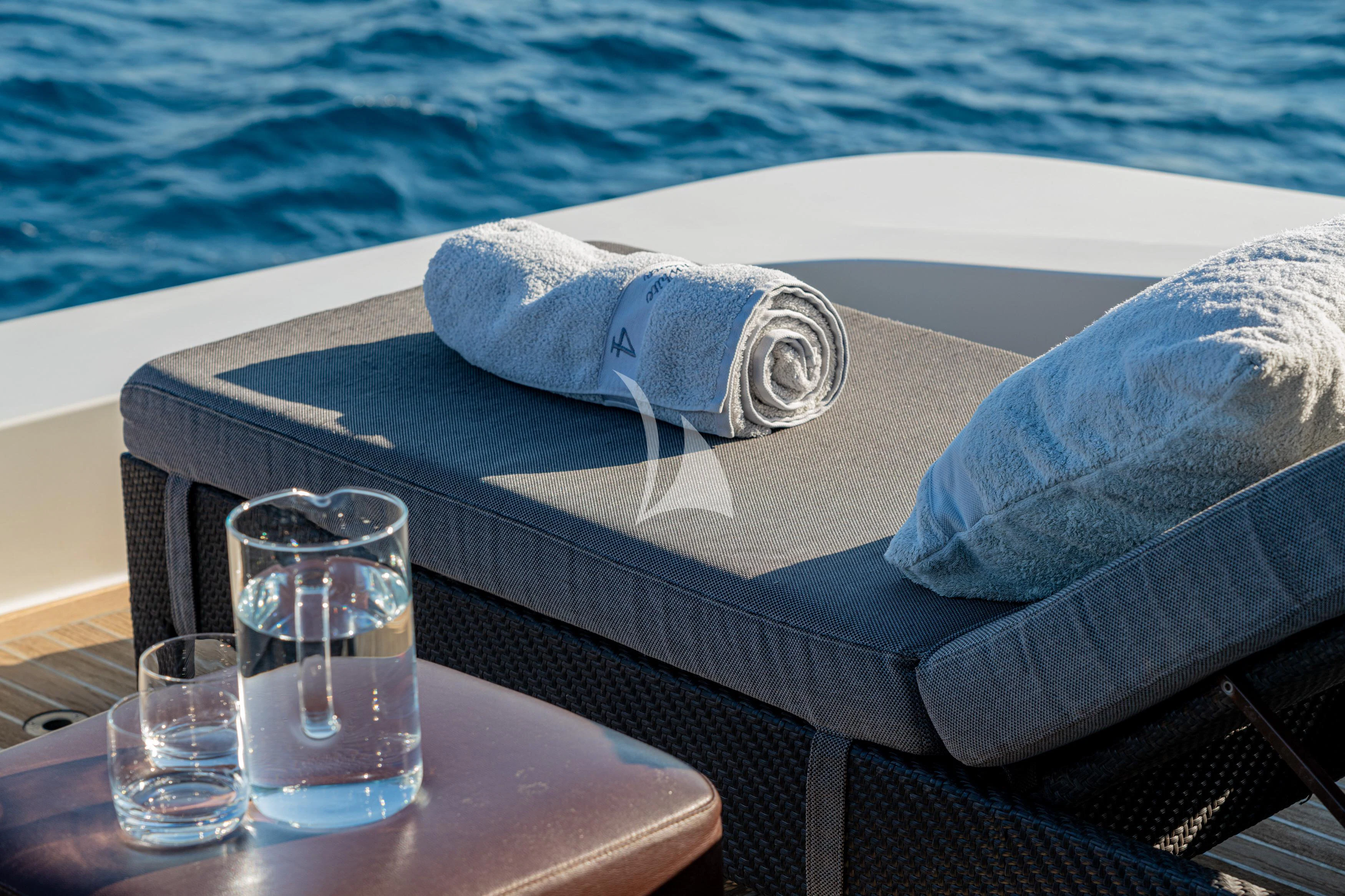 a towel on a chair by a pool aboard WHITEHAVEN Yacht for Sale