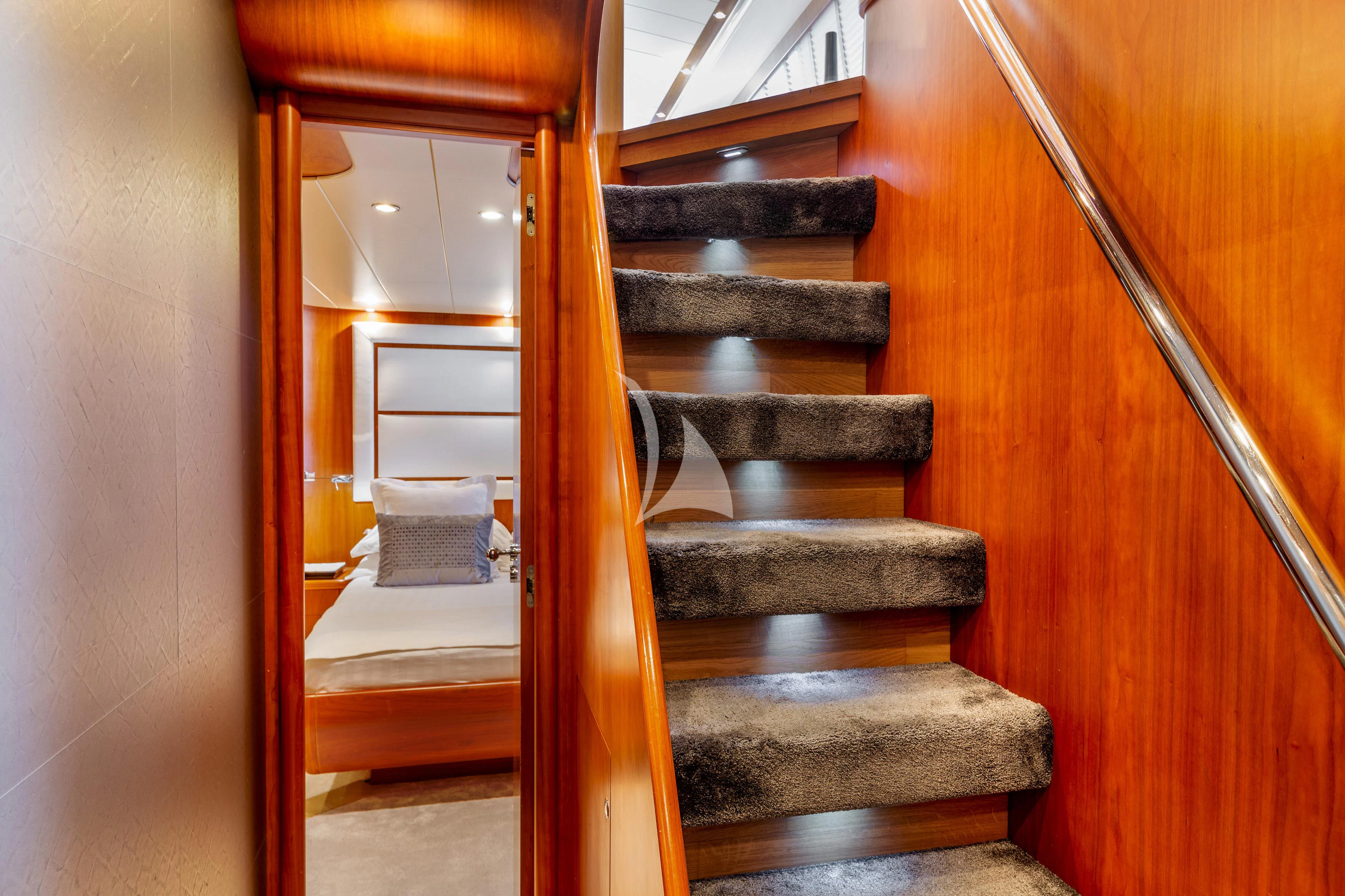 a staircase with a wood railing aboard WHITEHAVEN Yacht for Sale