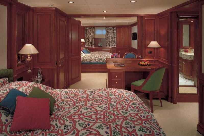 a bedroom with a bed and desk aboard CORINTHIAN Yacht for Sale