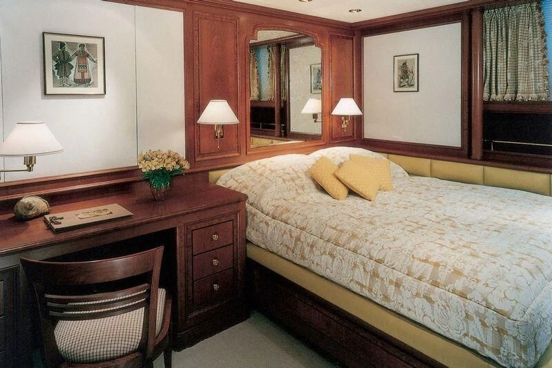 a hotel room with a bed and desk aboard CORINTHIAN Yacht for Sale
