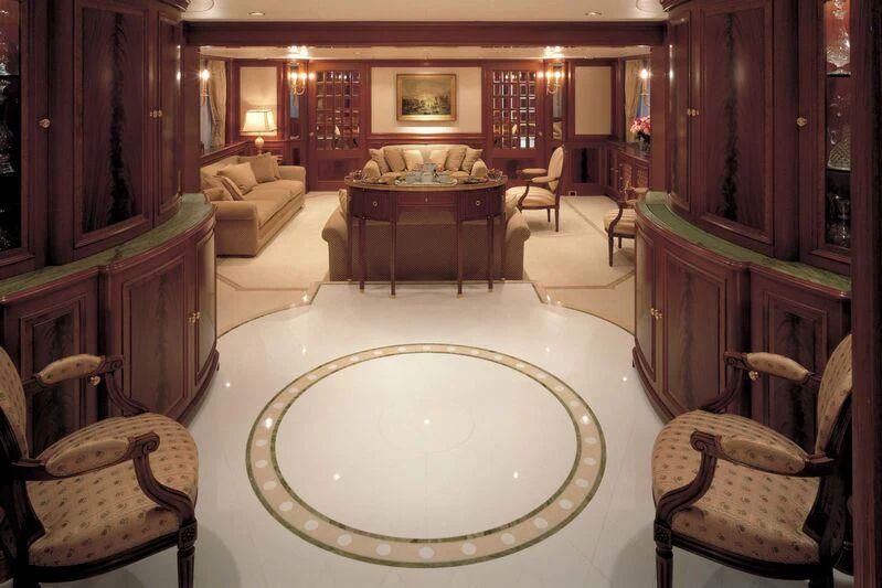 a large living room with a round table and chairs aboard CORINTHIAN Yacht for Sale