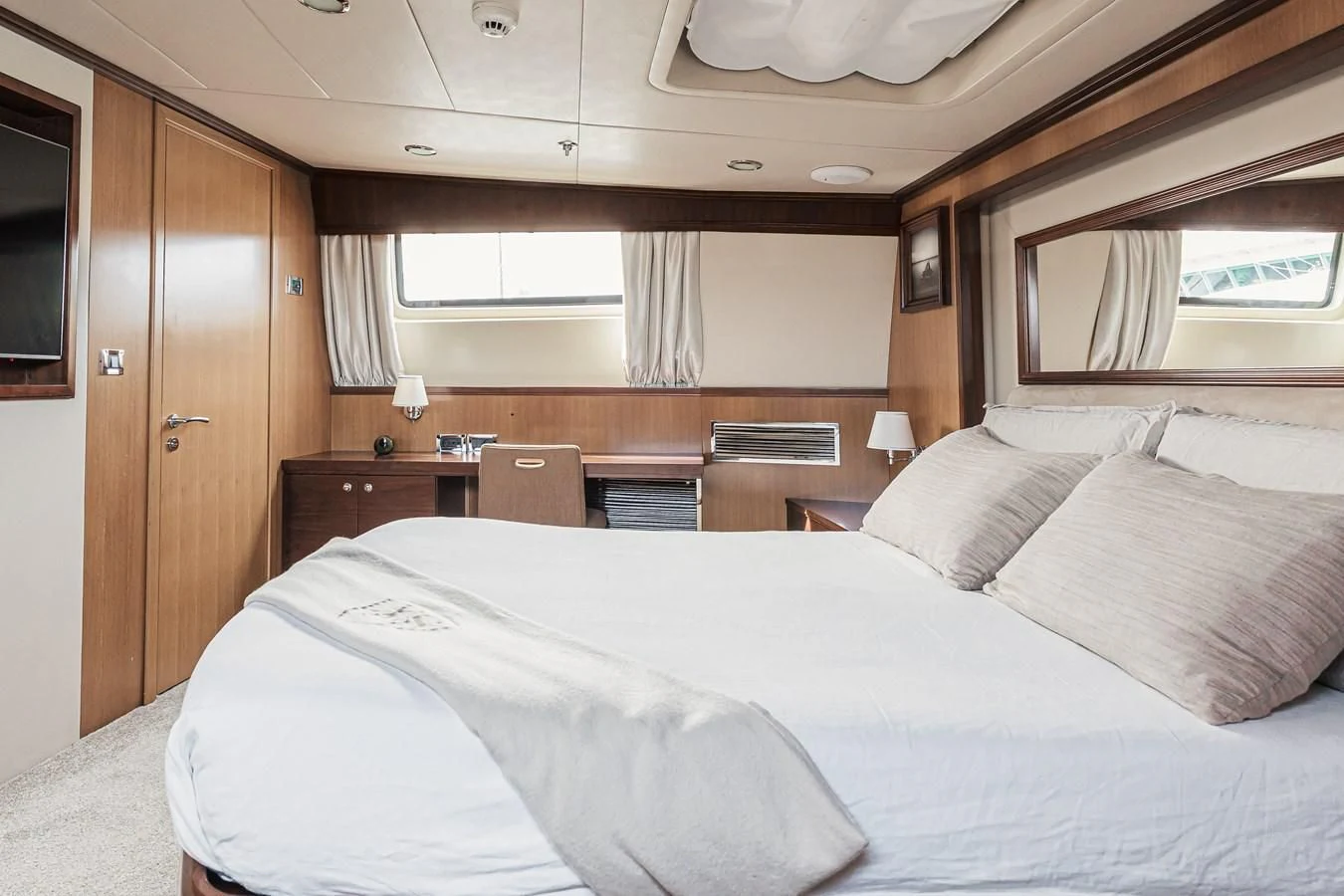 a bed with white sheets aboard XO OF THE SEAS Yacht for Sale