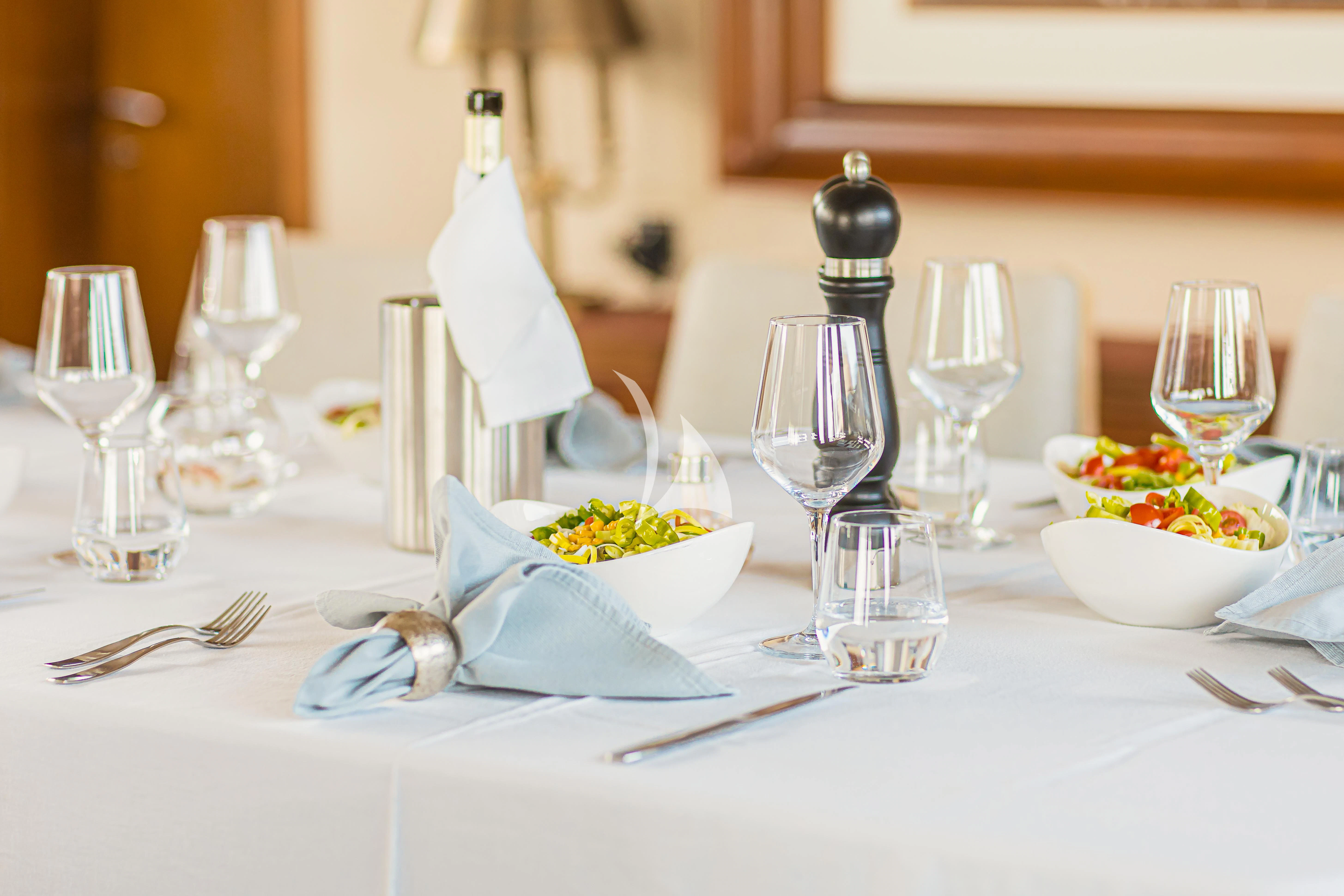 a table with silverware and silverware aboard XO OF THE SEAS Yacht for Sale