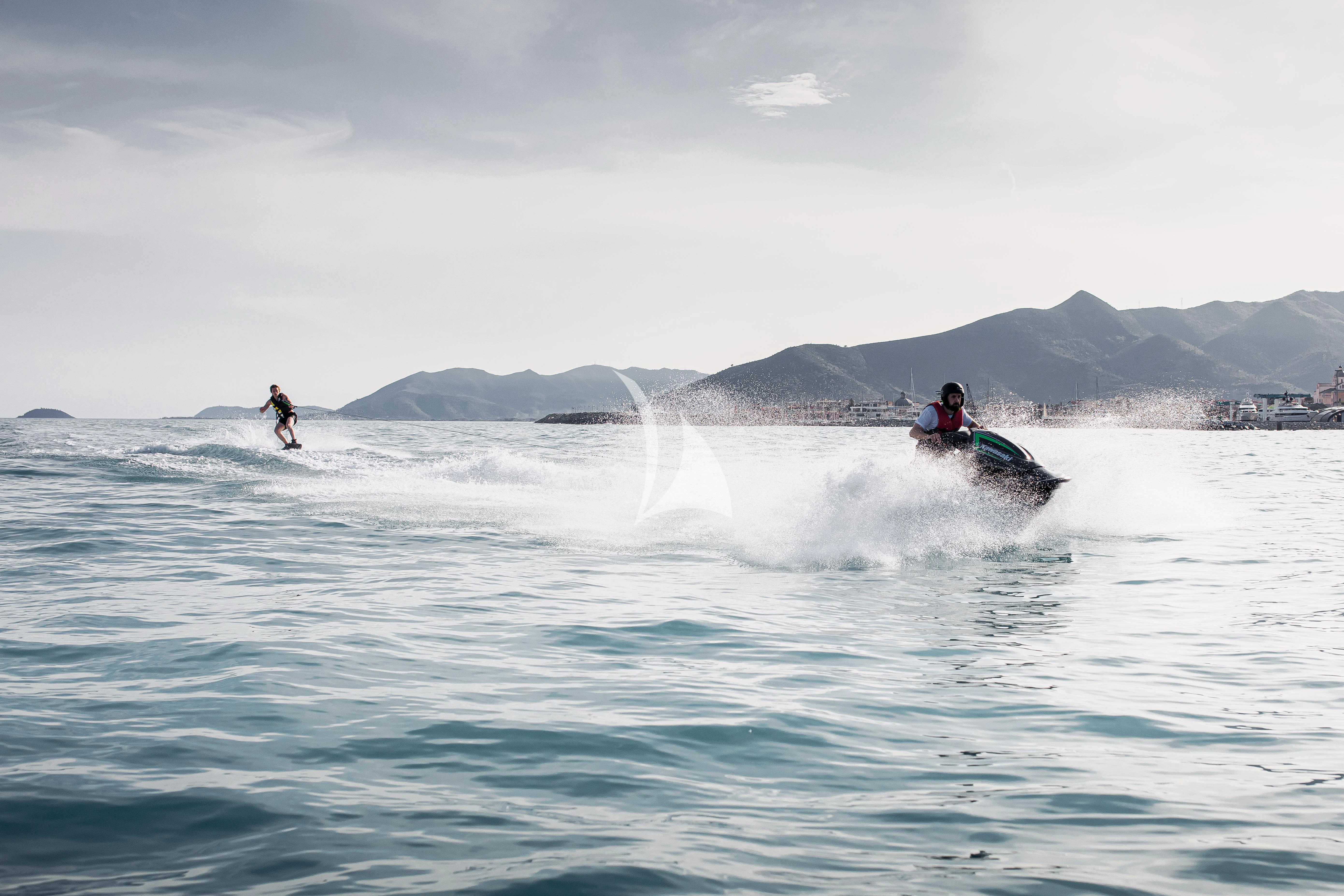 a group of people surfing aboard XO OF THE SEAS Yacht for Sale