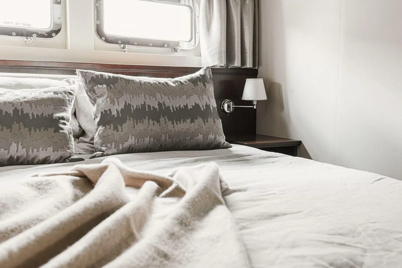 a bed with pillows aboard XO OF THE SEAS Yacht for Sale